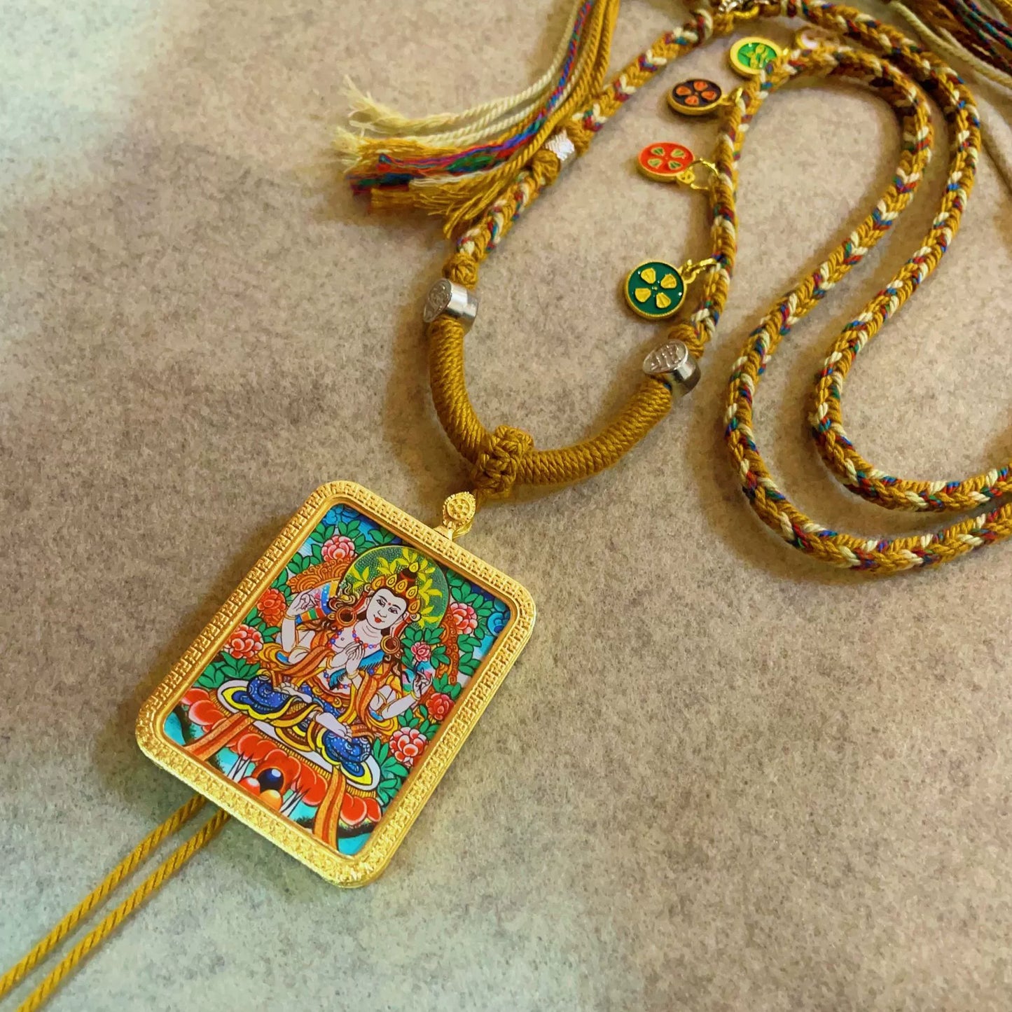 Four-Armed Avalokiteshvara - Handcrafted Gold Tibetan Thangka Necklace with Soft Yarn Cord