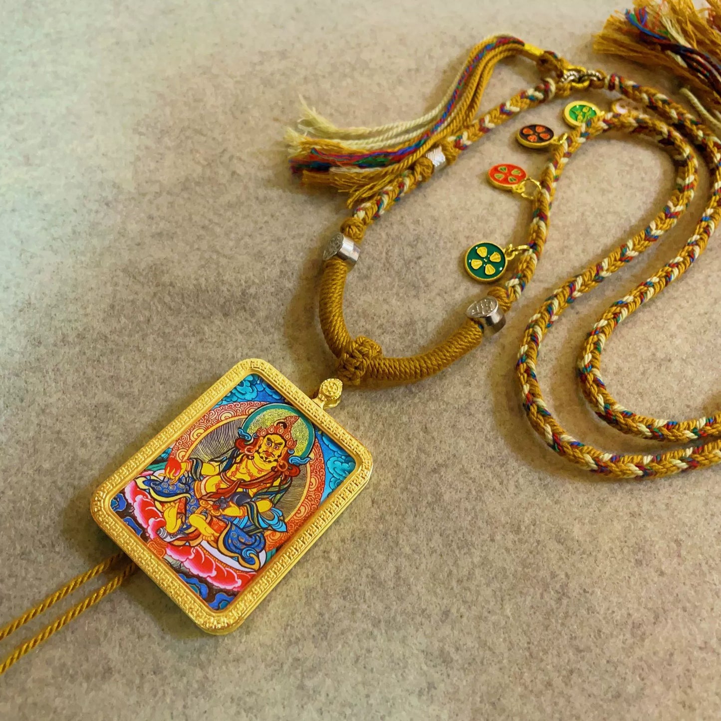 Yellow Jambhala (God of Wealth) - Handcrafted Gold Tibetan Thangka Necklace with Soft Yarn Cord